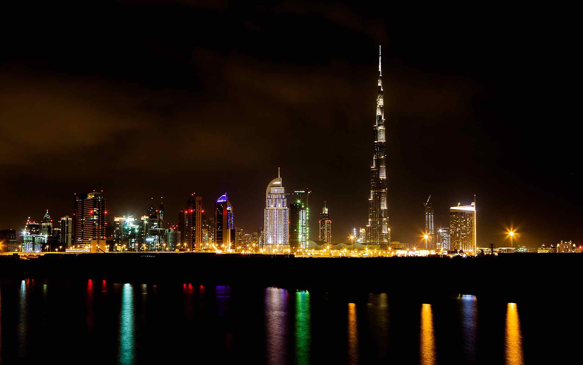 Burj Khalifa and Business Bay towers across the water at night